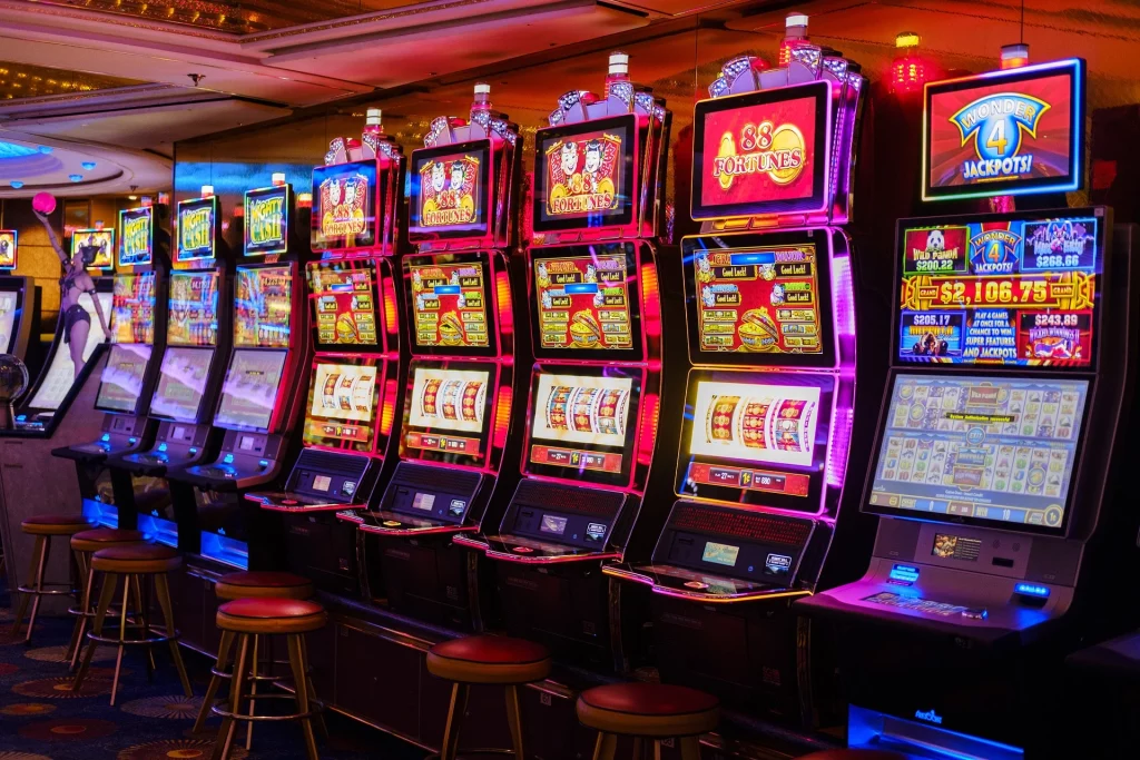 A vibrant and colorful image showcasing a variety of penny slot machines lined up in a casino